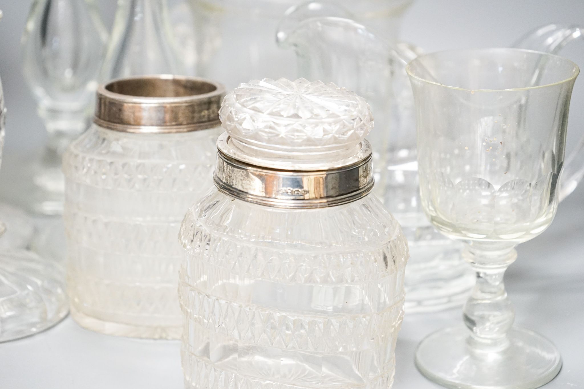 A trio of Colelfax and Fowler clear crystal candlesticks and other clear glasswares, jar height 15cm overall